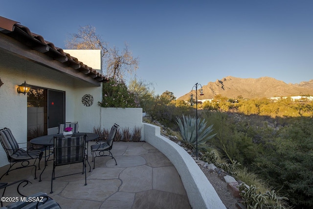 view of patio / terrace featuring a mountain view