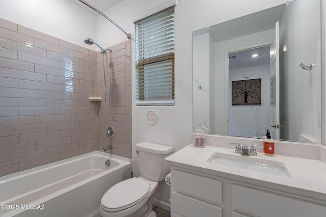 full bathroom with vanity, tiled shower / bath combo, and toilet