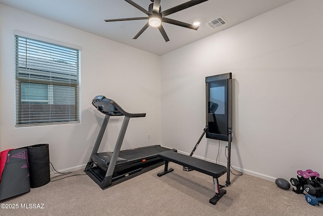 exercise room featuring light colored carpet and ceiling fan