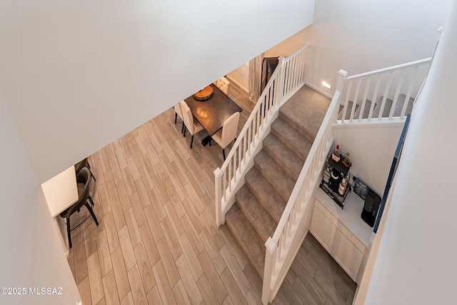 stairs with hardwood / wood-style flooring