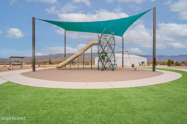 view of play area featuring a mountain view and a lawn