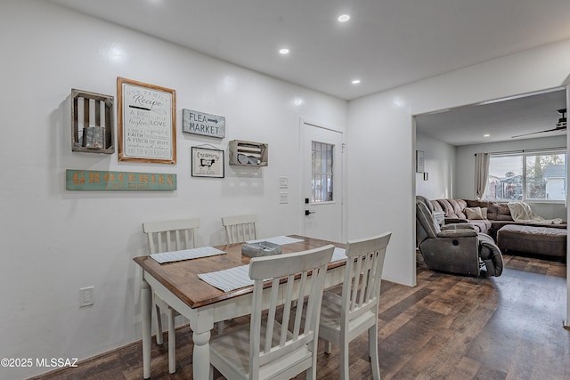 dining space featuring ceiling fan and dark wood-type flooring