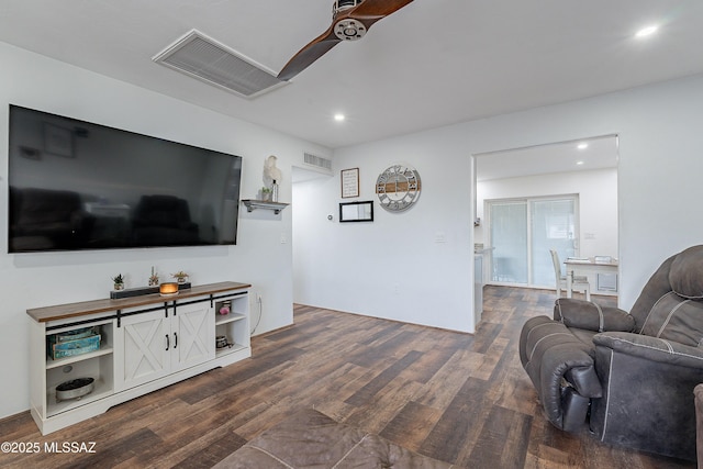 living room with ceiling fan and dark hardwood / wood-style flooring