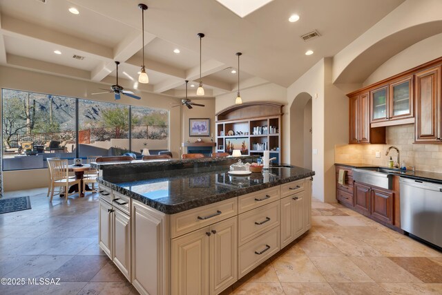 kitchen with coffered ceiling, beam ceiling, dark stone counters, stainless steel dishwasher, and sink