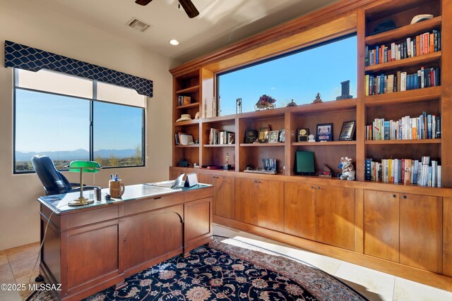 office area featuring ceiling fan, light tile patterned floors, and a mountain view