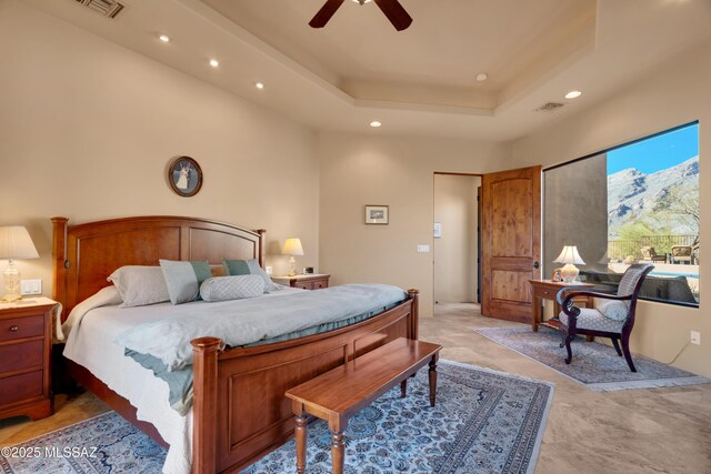 bedroom featuring a raised ceiling and ceiling fan