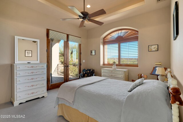 carpeted bedroom with ceiling fan, access to exterior, french doors, and multiple windows