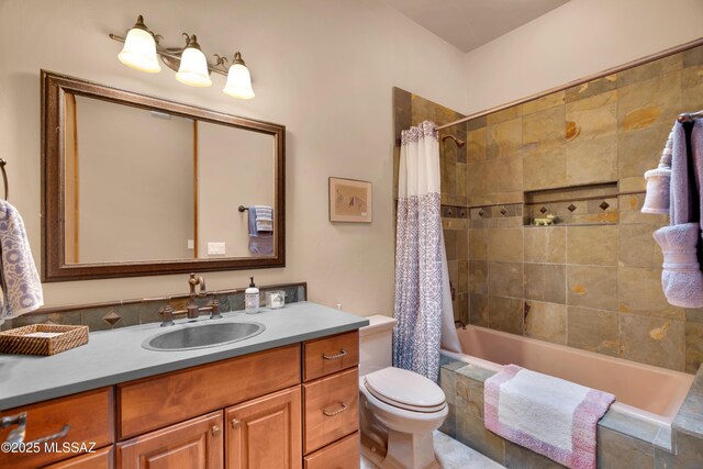 full bathroom featuring toilet, vanity, and shower / tub combo with curtain