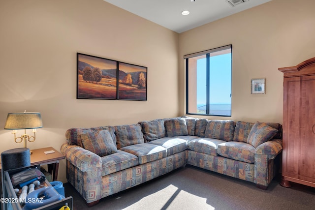 living room with dark colored carpet