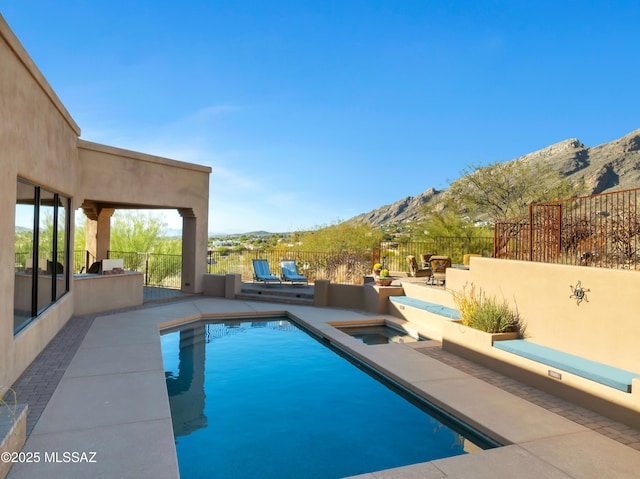 view of pool with a mountain view, an in ground hot tub, and a patio