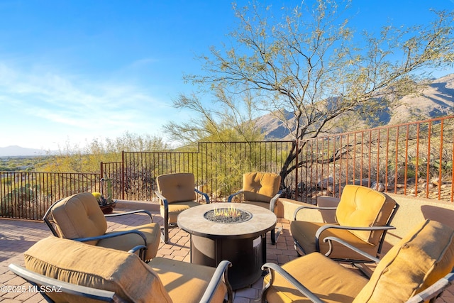 view of patio / terrace featuring a mountain view and an outdoor fire pit