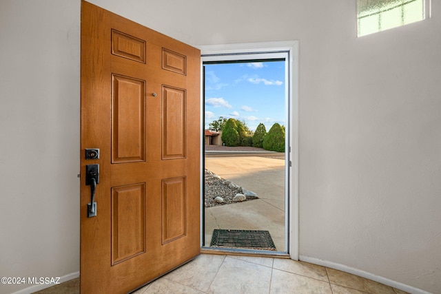 foyer with light tile patterned floors and a healthy amount of sunlight