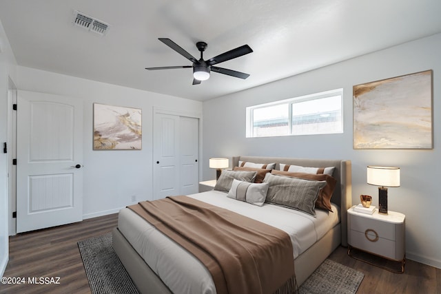 bedroom featuring a closet, ceiling fan, and dark wood-type flooring