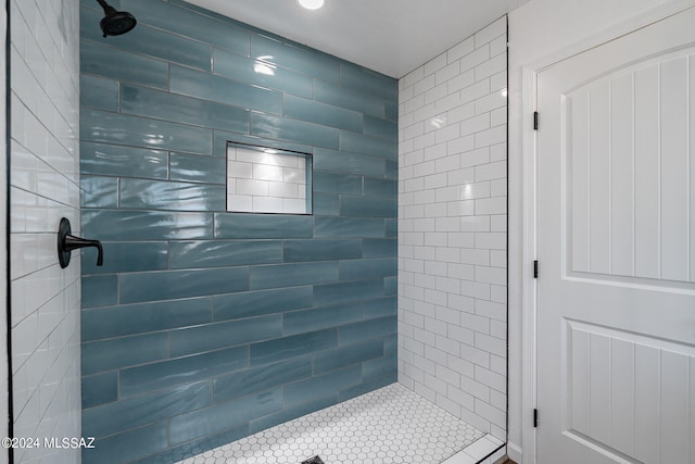 bathroom with a tile shower