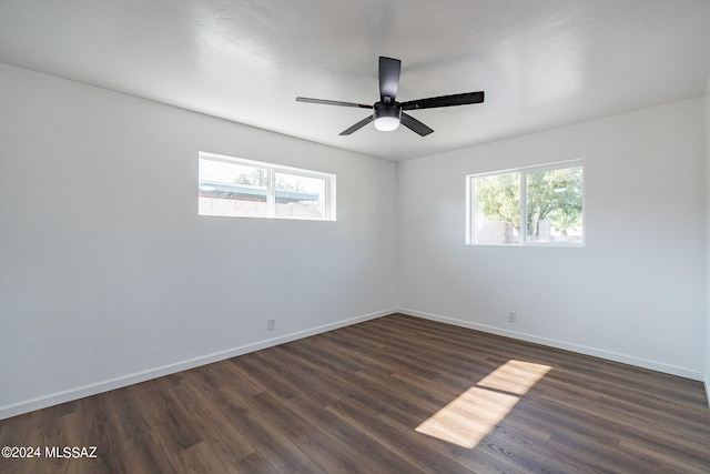 unfurnished room with dark hardwood / wood-style floors, ceiling fan, and a healthy amount of sunlight