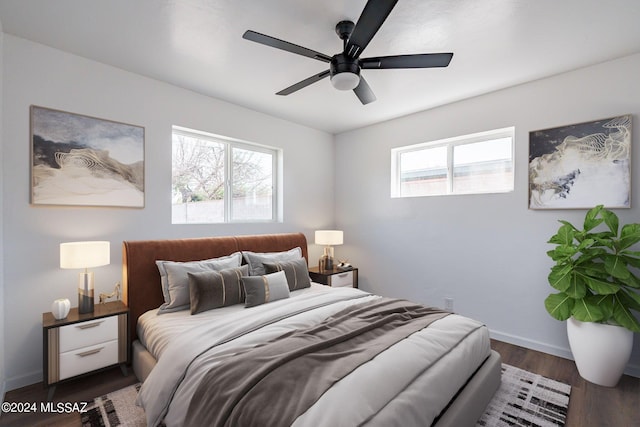 bedroom with ceiling fan and dark wood-type flooring