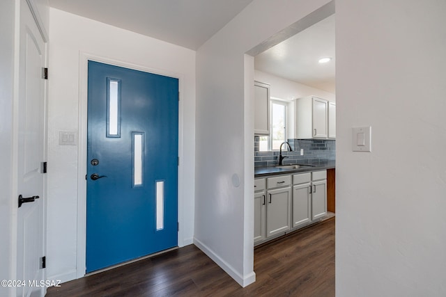 entryway with dark hardwood / wood-style flooring and sink