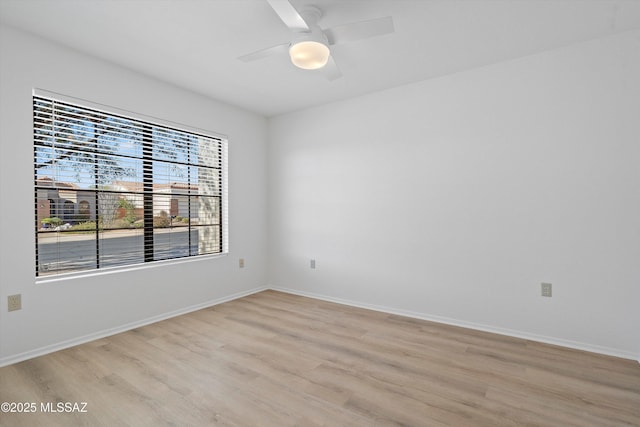 empty room featuring light hardwood / wood-style flooring and ceiling fan