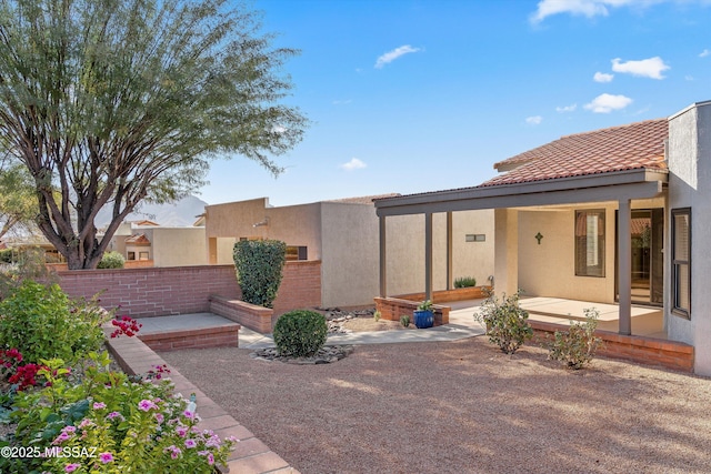 rear view of house with a patio