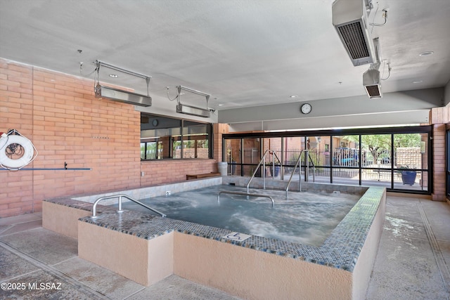 view of swimming pool featuring an indoor in ground hot tub