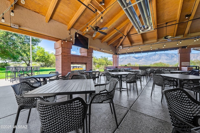 view of patio / terrace with a gazebo, an outdoor brick fireplace, and ceiling fan