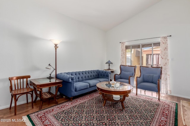 living room with wood-type flooring and vaulted ceiling