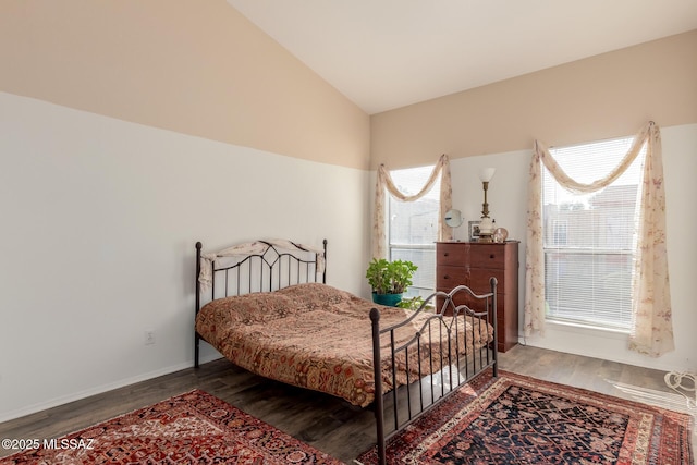 bedroom with wood-type flooring and lofted ceiling