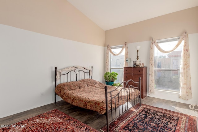 bedroom with hardwood / wood-style floors and vaulted ceiling