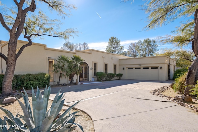 pueblo-style house featuring a garage