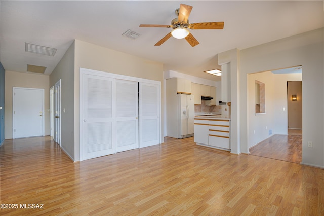 unfurnished living room with ceiling fan and light hardwood / wood-style floors