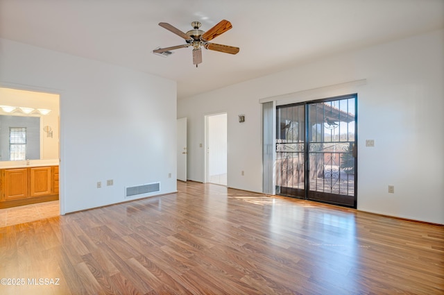 spare room featuring ceiling fan, sink, and light hardwood / wood-style flooring