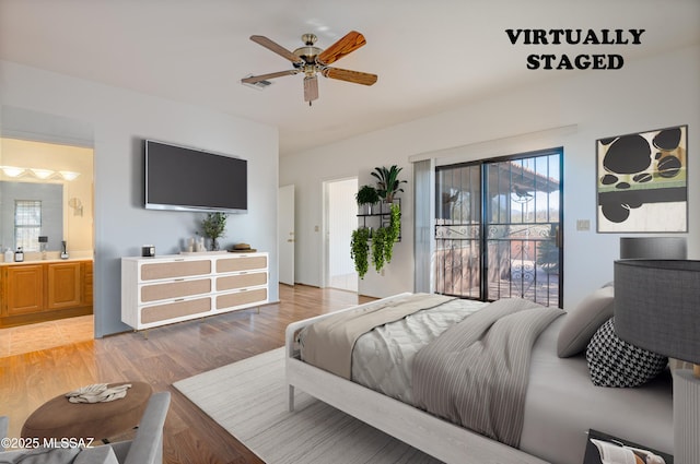 bedroom featuring hardwood / wood-style flooring, ensuite bathroom, access to exterior, and ceiling fan