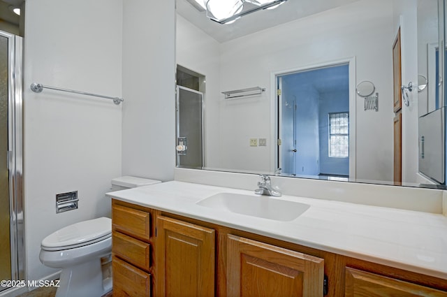 bathroom featuring vanity, toilet, and walk in shower