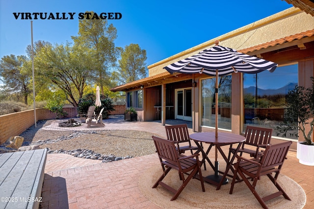 view of patio featuring an outdoor fire pit