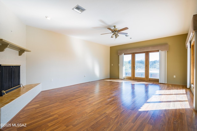 unfurnished living room featuring hardwood / wood-style flooring and ceiling fan