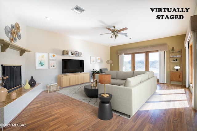 living room featuring light hardwood / wood-style floors and ceiling fan