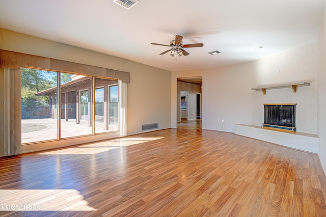 unfurnished living room featuring ceiling fan and light wood-type flooring