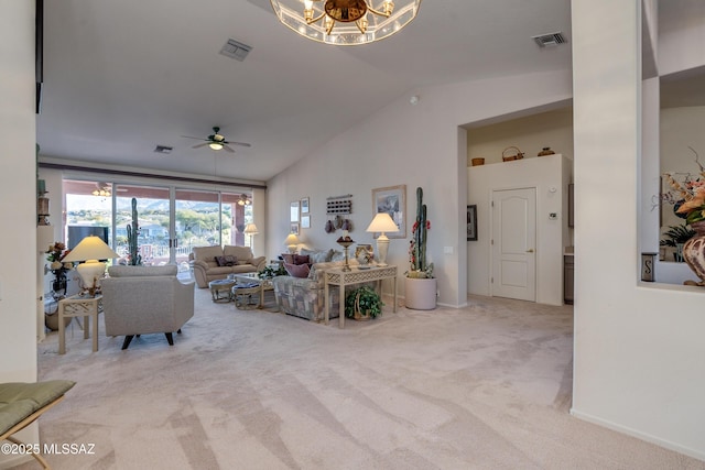 living room with ceiling fan with notable chandelier, vaulted ceiling, and light carpet