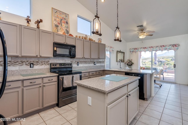 kitchen with light tile patterned floors, black appliances, tasteful backsplash, a kitchen island, and ceiling fan