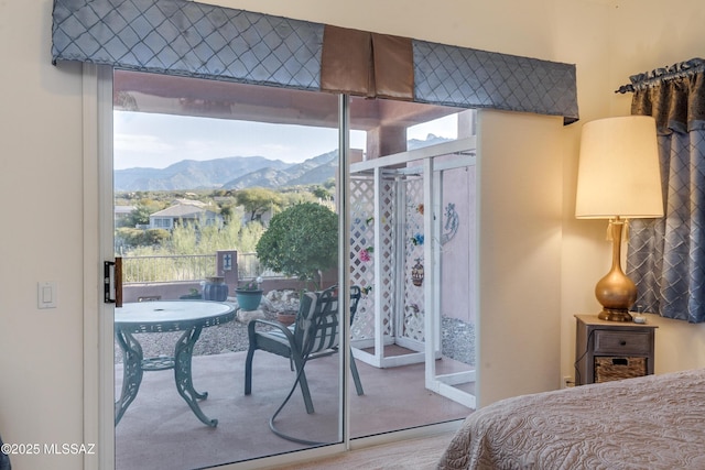 bedroom featuring multiple windows and a mountain view