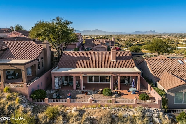 view of front of property with a mountain view and a patio area