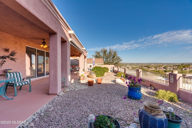 view of yard featuring a patio area and ceiling fan