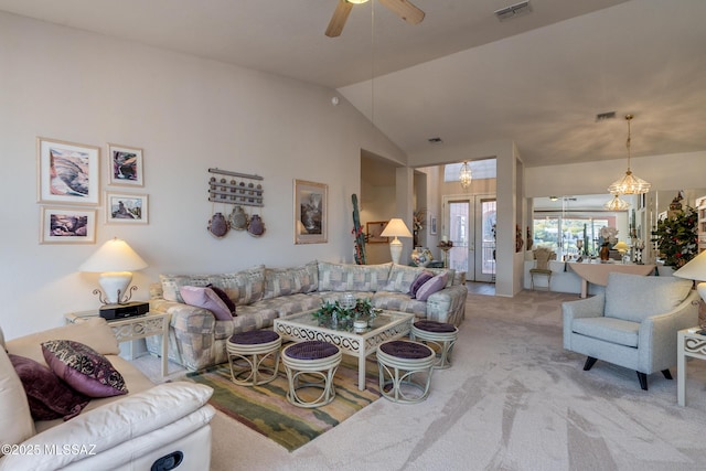 living room featuring ceiling fan with notable chandelier, lofted ceiling, light carpet, and french doors