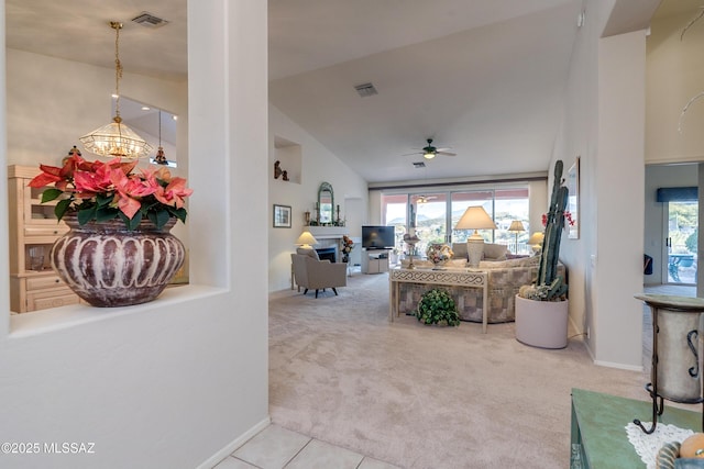 living room featuring ceiling fan with notable chandelier, lofted ceiling, and carpet