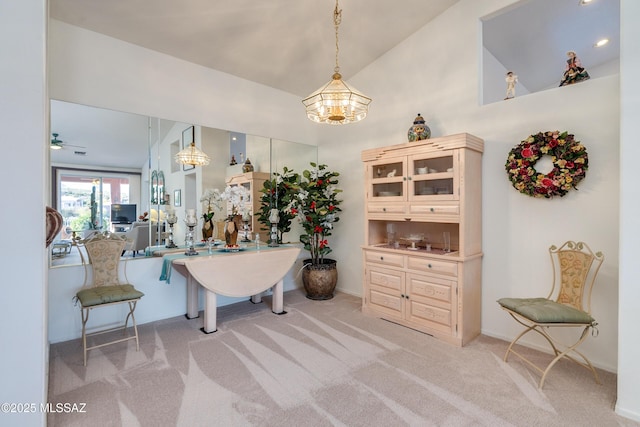 interior space with lofted ceiling and ceiling fan with notable chandelier