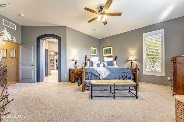 bedroom with ceiling fan and light carpet