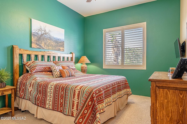 bedroom featuring light carpet and ceiling fan