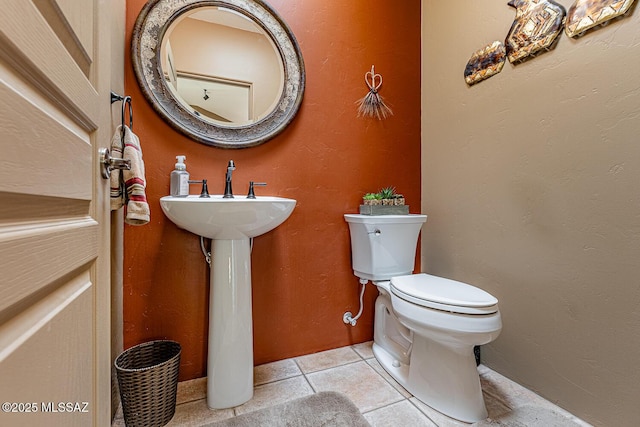 bathroom with tile patterned floors, toilet, and sink