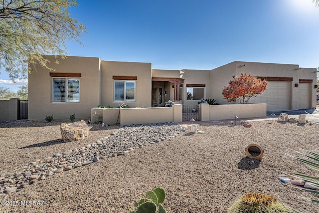 pueblo revival-style home with a garage