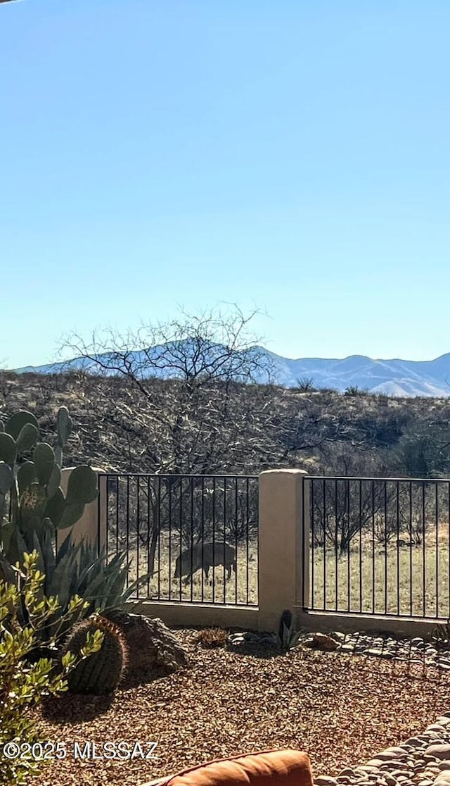 view of gate with a mountain view